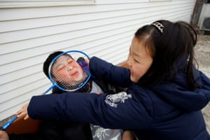 Chan-hee holds a badminton racket against Chae-hee's face