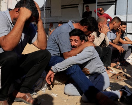 Men cry during the funeral of Palestinians killed in Israeli strikes in Khan Younis, southern Gaza Strip, 25 May 2025.