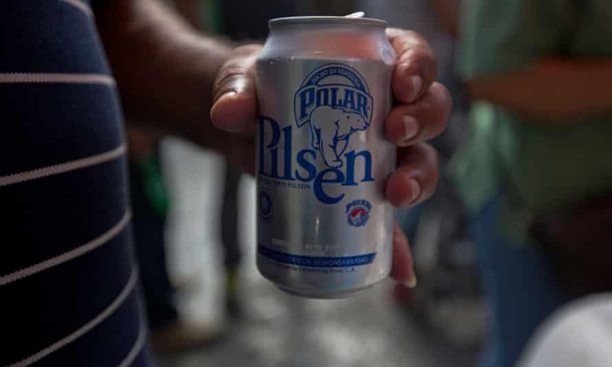 A customer drinks a Polar beer in downtown Caracas.