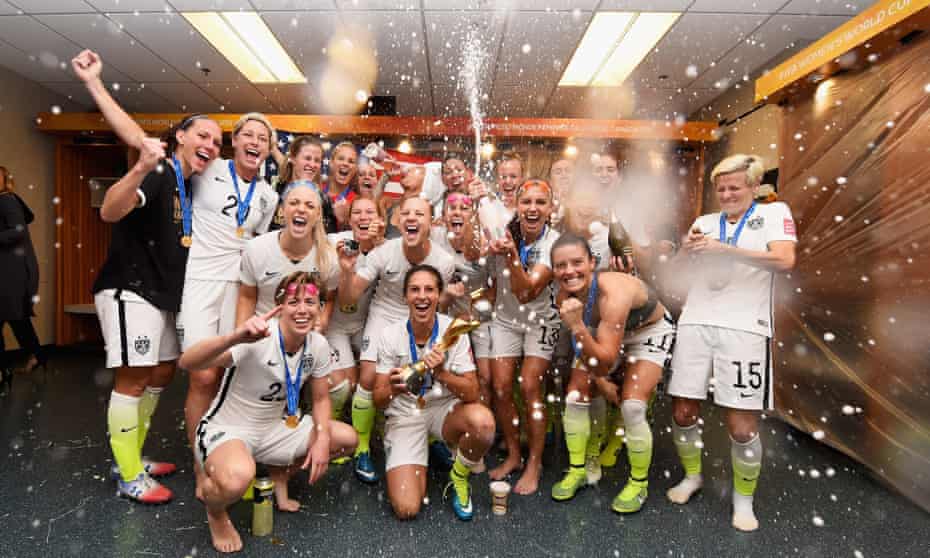 Carli Lloyd celebrates with the trophy and her team mates in the locker room after winning the FIFA Women’s World Cup 2015 Final between USA and Japan.