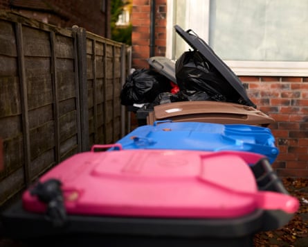 Full wheelie bins outside a house