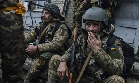 Ukrainian soldiers rest near their position in Bakhmut, Donetsk region