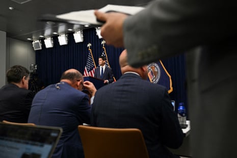 people sit as a man stands at a lectern