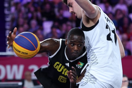 Guyana’s Kevin Mickle is challenged by Christian Martin of New Zealand