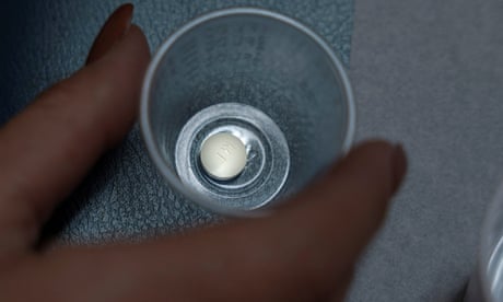 A patient prepares to take mifepristone, the first pill given in a medical abortion.