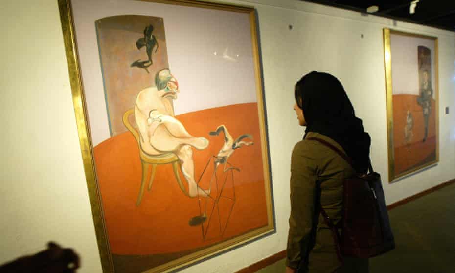 An Iranian woman looks at the lefthand panel of Francis Bacon’s triptych, Two Figures Lying on a Bed with Attendant” (1968).