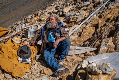 Brian Busse rests after climbing upslope, surface mining for aquamarine crystals, at his 11,500 foot mining claim on Mount Antero, Colorado.