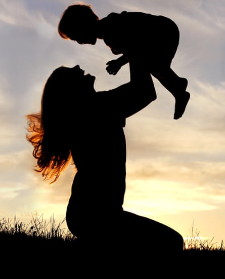 Silhouette of mother playing outside with her child