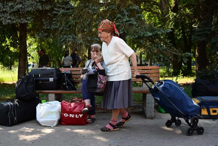 Residents of the city of Sloviansk and neighbouring towns wait for buses to be evacuated to the city of Dnipro, on 6 July.