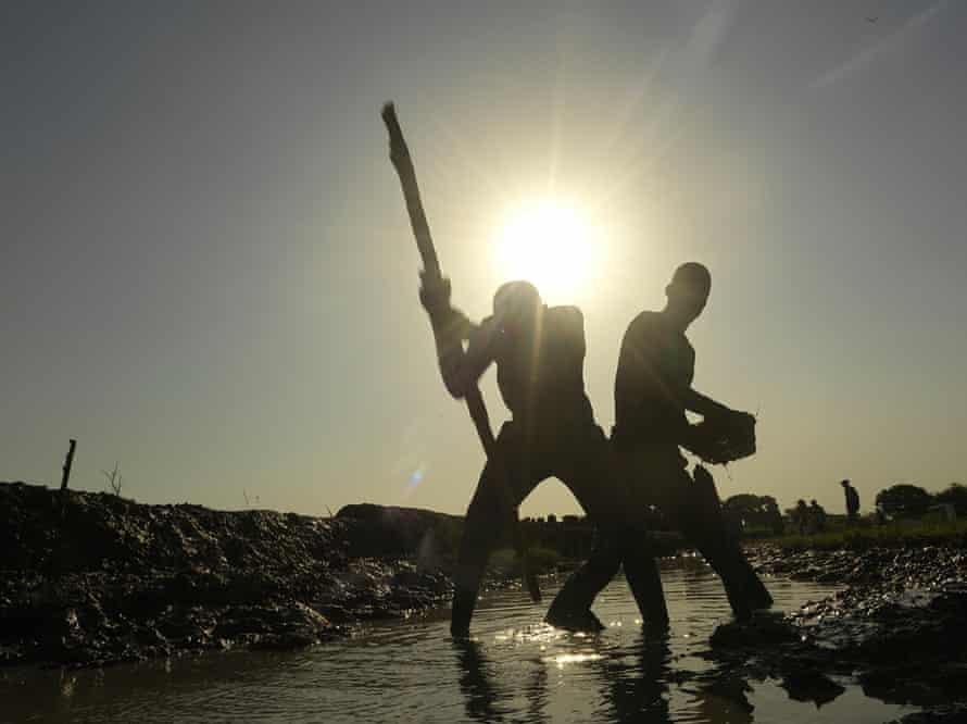 Volunteers work around the clock to repair the dyke to keep their airstrip safe