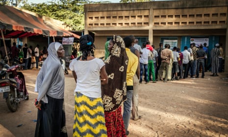 Burkinabe people line up at a polling station to cast their ballots in the general elections in Ouagadougou.