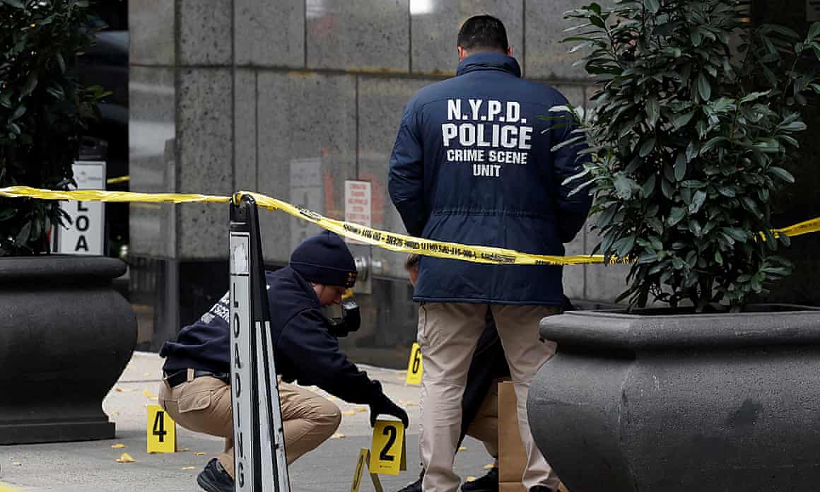Members of the NYPD near where Brian Thompson was shot and killed in New York City