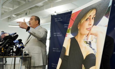 Brian Panish, left, an attorney for the family of Halyna Hutchins, speaks next to a portrait of Hutchins in February.
