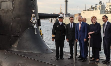 Emmanuel Macron and Malcolm Turnbull with five other people standing on the deck of a submarine.