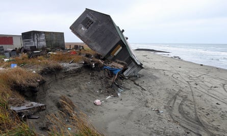 A home destroyed by beach erosion in Shishmaref tips over.