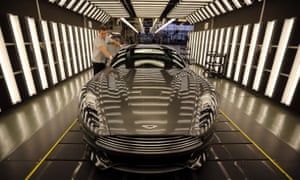 An Aston Martin Vanquish is inspected by hand inside a light booth at the company’s headquarters and production plant in Gaydon.