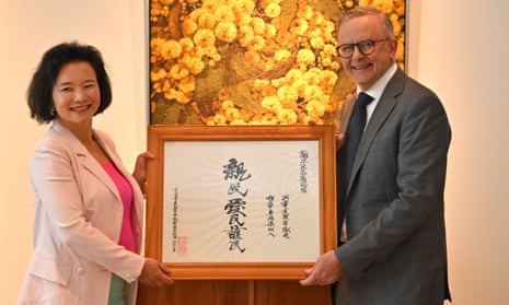 Australian journalist Cheng Lei presents prime minister Anthony Albanese with a gift at Parliament House