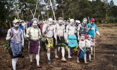 Painted in clay for a customary ritual to honour the dead, Ganiga tribes people honour Joe Leahy, at his former coffee plantation in Papua New Guinea