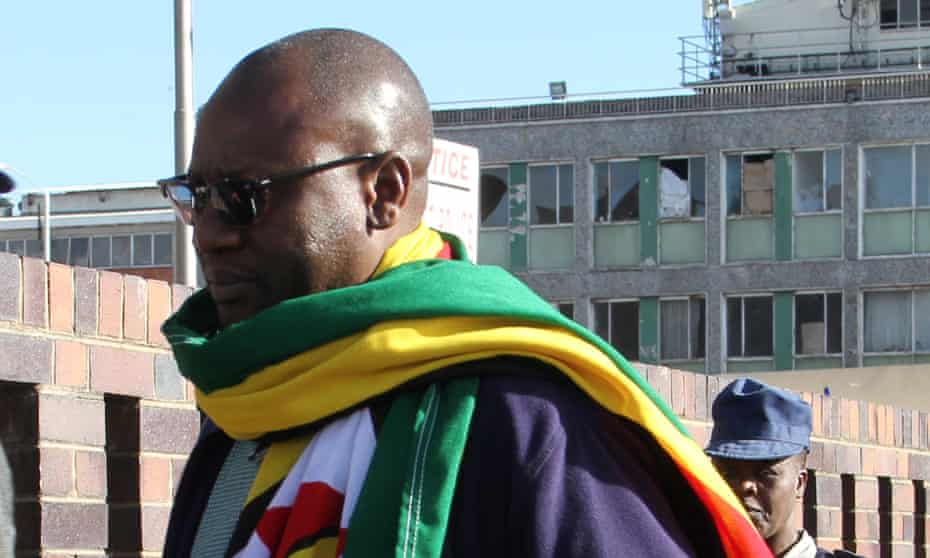 #ThisFlag movement leader Evan Mawarire, a 39-year-old pastor, arrives at a police station Harare on Tuesday.