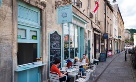The Fine Cheese Co Company shop in Walcot Street, Bath, Somerset, England, UK. People sit at pavement tables outside in front.