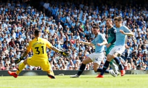 Manchester City’s Ederson saves a shot from Tottenham’s Christian Eriksen as Manchester City’s John Stones and Aymeric Laporte look on.