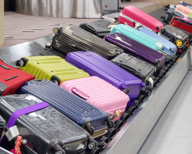 Bright suitcases on luggage conveyor belt