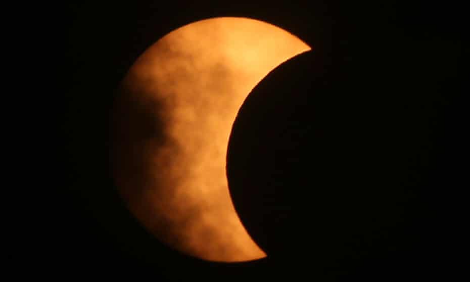 The moon covers part of the sun in a partial solar eclipse, seen from Bangkok in June 2020