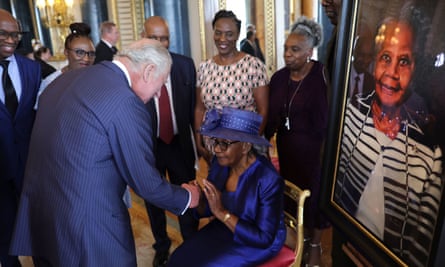 King Charles shakes hands with Gilda Oliver during a reception at Buckingham Palace to mark the 75th anniversary of the arrival of the Empire Windrush