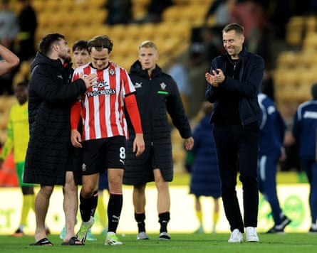 Southampton manager Tonda Eckert celebrates with his players after their 1-0 win at Norwich.