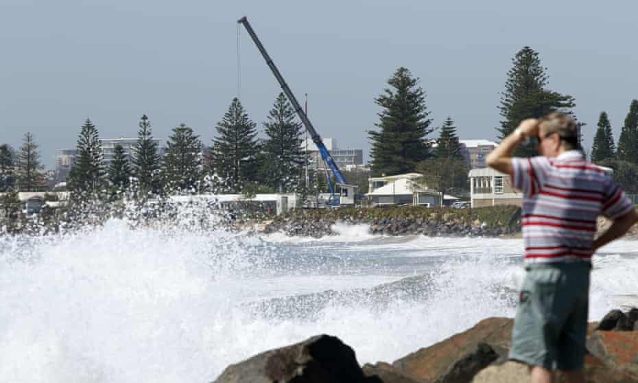 Newcastle City council uses a crane to move cabins from the Stockton caravan park