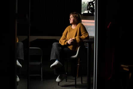 a woman sits in a radio station