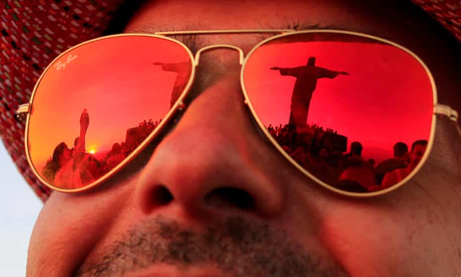  The statue of Christ the Redeemer is reflected in the sunglasses of a tourist in Rio de Janeiro.