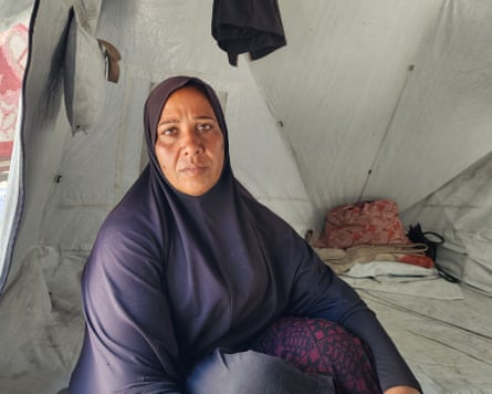Abeer Ghaban sitting in a tent.