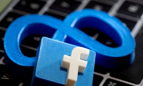 An image of the 3D-printed logos of Facebook and Meta laid on a keyboard.