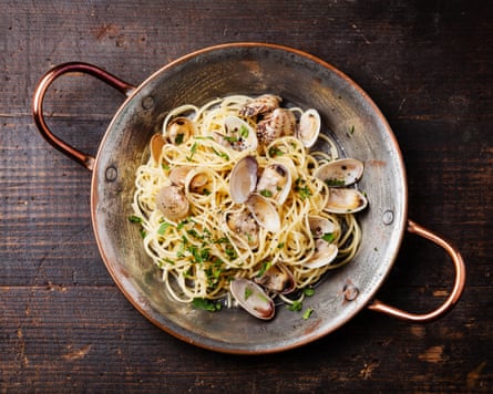 Seafood pasta with clams spaghetti alle vongole on wooden background.