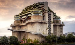 A large concrete air raid shelter with trees planted on its roof and upper floors