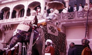 Queen Elizabeth II riding an elephant during her visit to India in 1961.