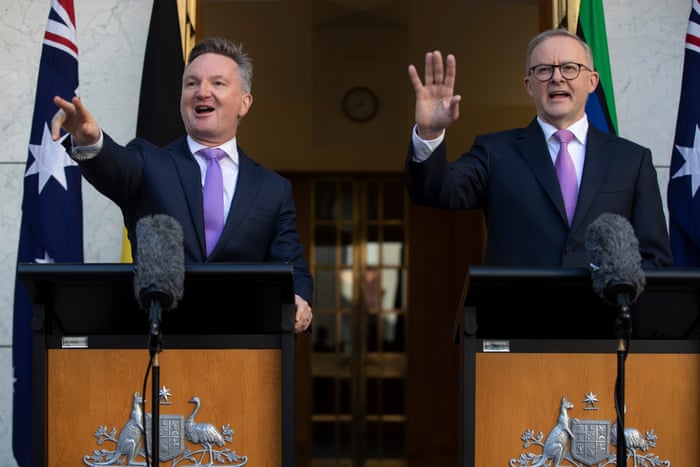 Anthony Albanese and Chris Bowen raising hands