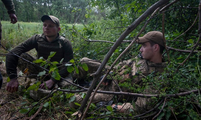 Ukrainian servicemen rest at a position on a front line in the Kharkiv region, Ukraine.