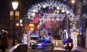 A police car by the entrance to the Christmas market in Strasbourg after the shooting