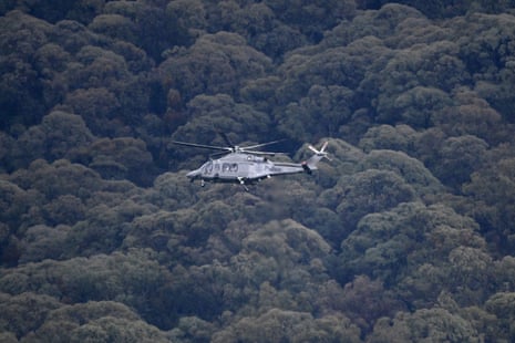 A Victoria police helicopter circles above dense trees