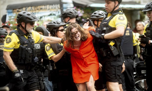 Police officers detain a protester against rightwing demonstrators in Portland, Oregon on Saturday.