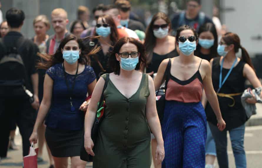 People wear face masks in response to smoke haze in Sydney.