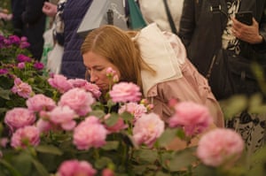 Woman smelling roses.