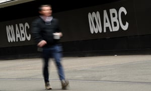 Man in front of ABC sign