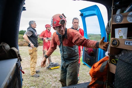 Men unload a vehicle.