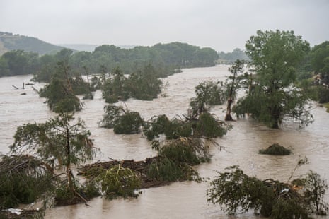 Trees emerge from flood waters along the Guadalupe River on 4 July 2025 in Kerrville, Texas.