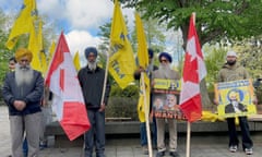 Sikh men with with flags and placards.