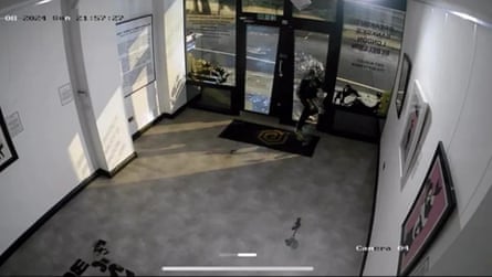 CCTV of a man smashing the glass door window of an art gallery
