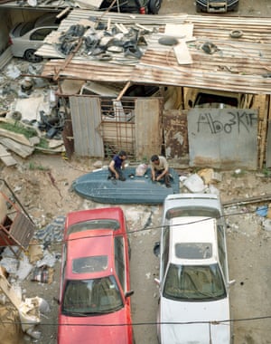 Two friends share a coffee on a makeshift table outside the Alsama centre in Shatila.